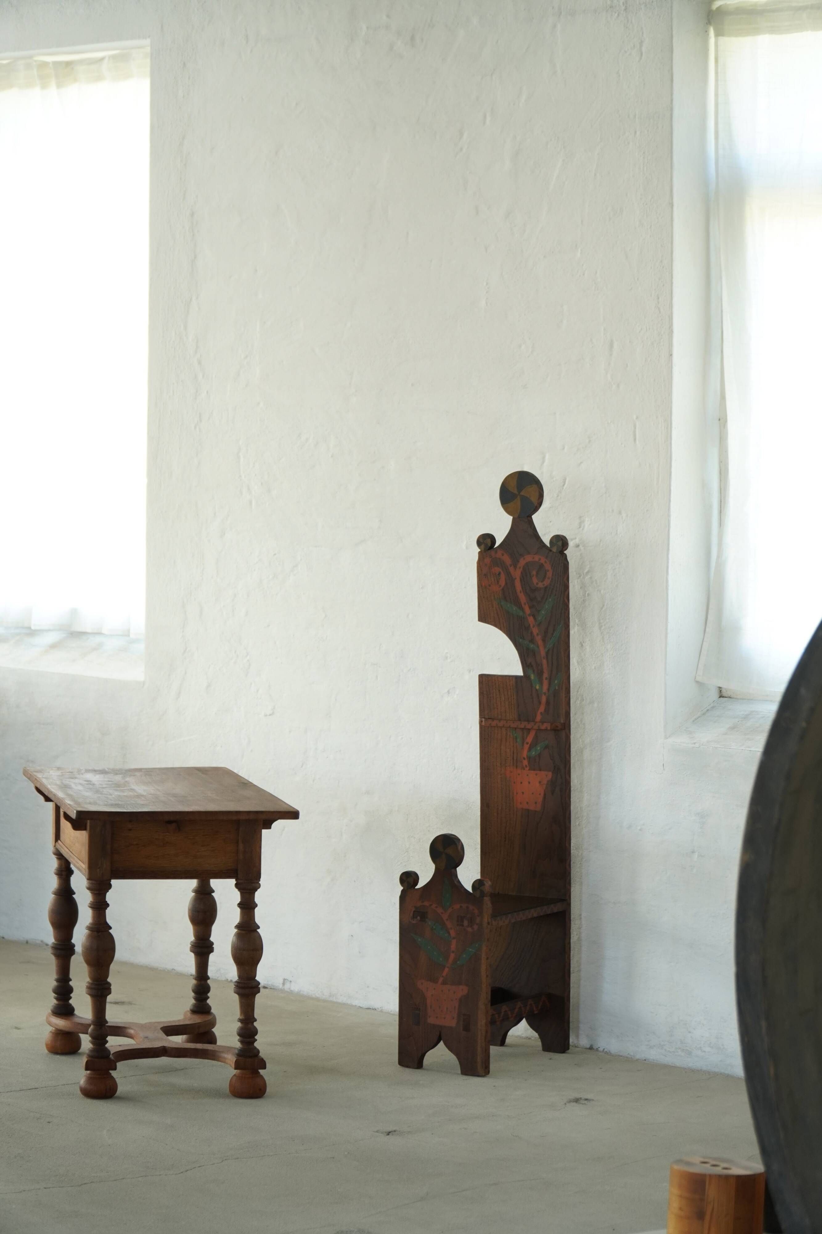 Danish popular art chair with a high back, made of oak, featuring hand-painted decoration, dated 1876.