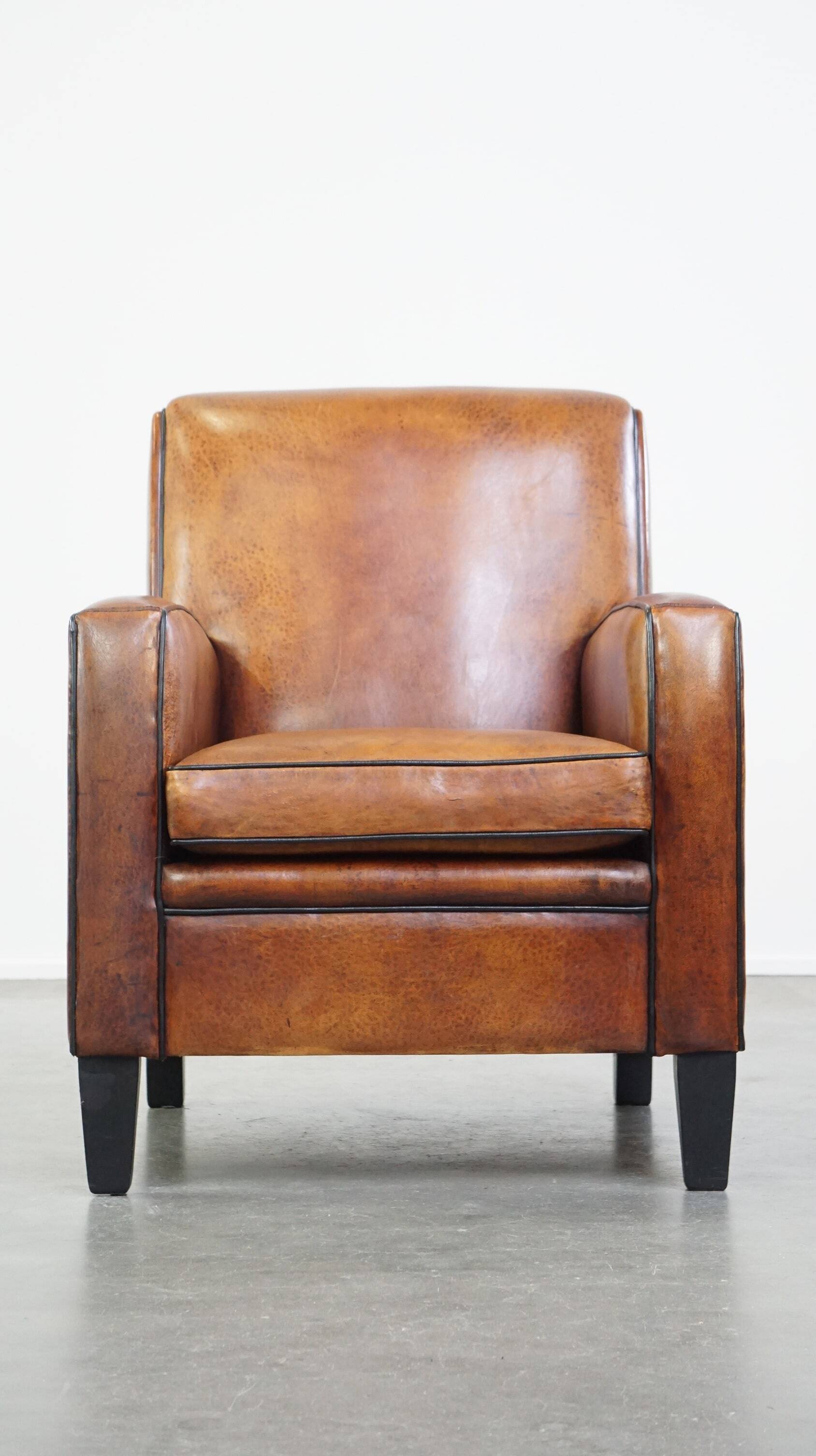 Art Deco design sheepskin leather armchair with a stunning patina