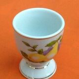 White porcelain egg cup decorated with pears / grapes.