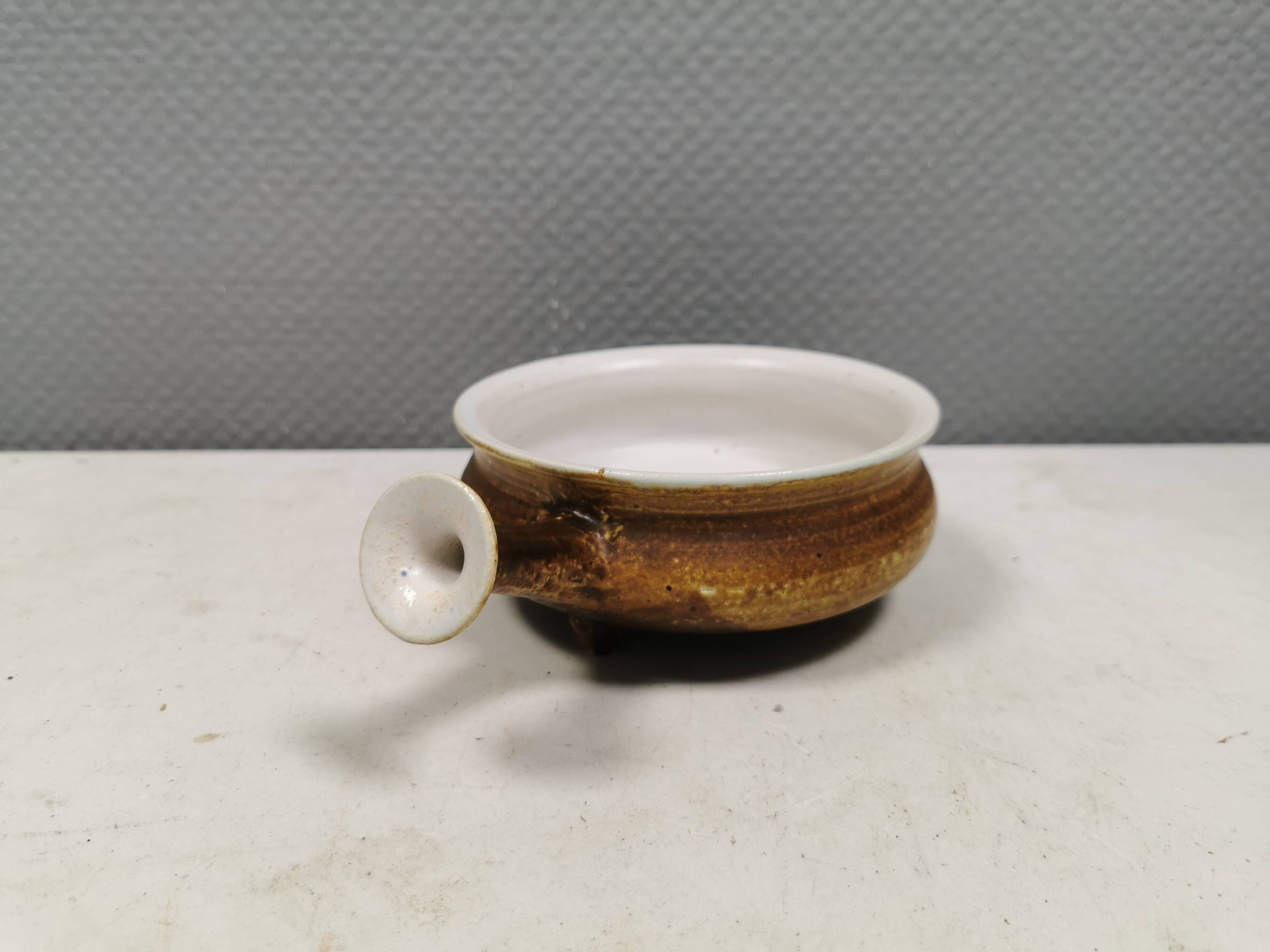 Small ceramic bowl with handle, in golden colours. Danish 1960-70s