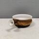 Small ceramic bowl with handle, in golden colours. Danish 1960-70s