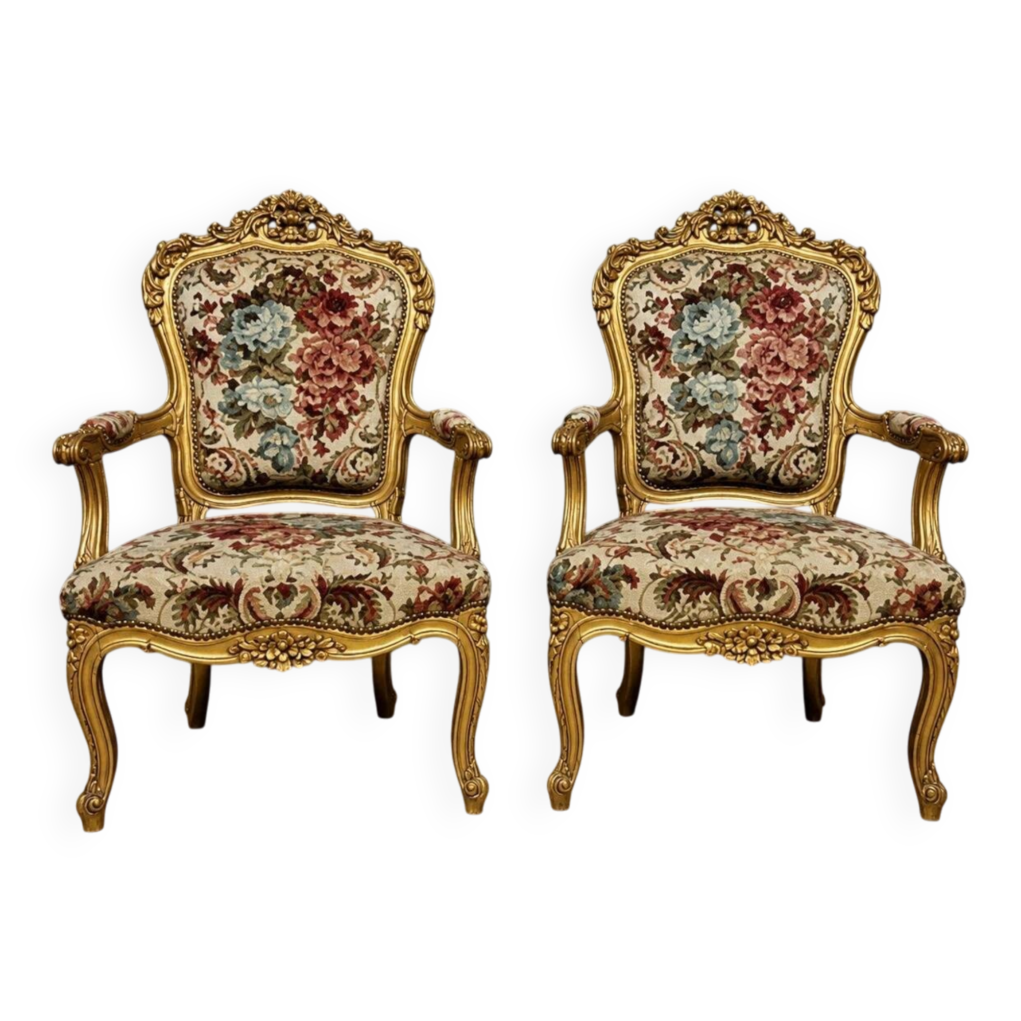 Pair of carved and gilded cabriolet armchairs in the Louis XV style.