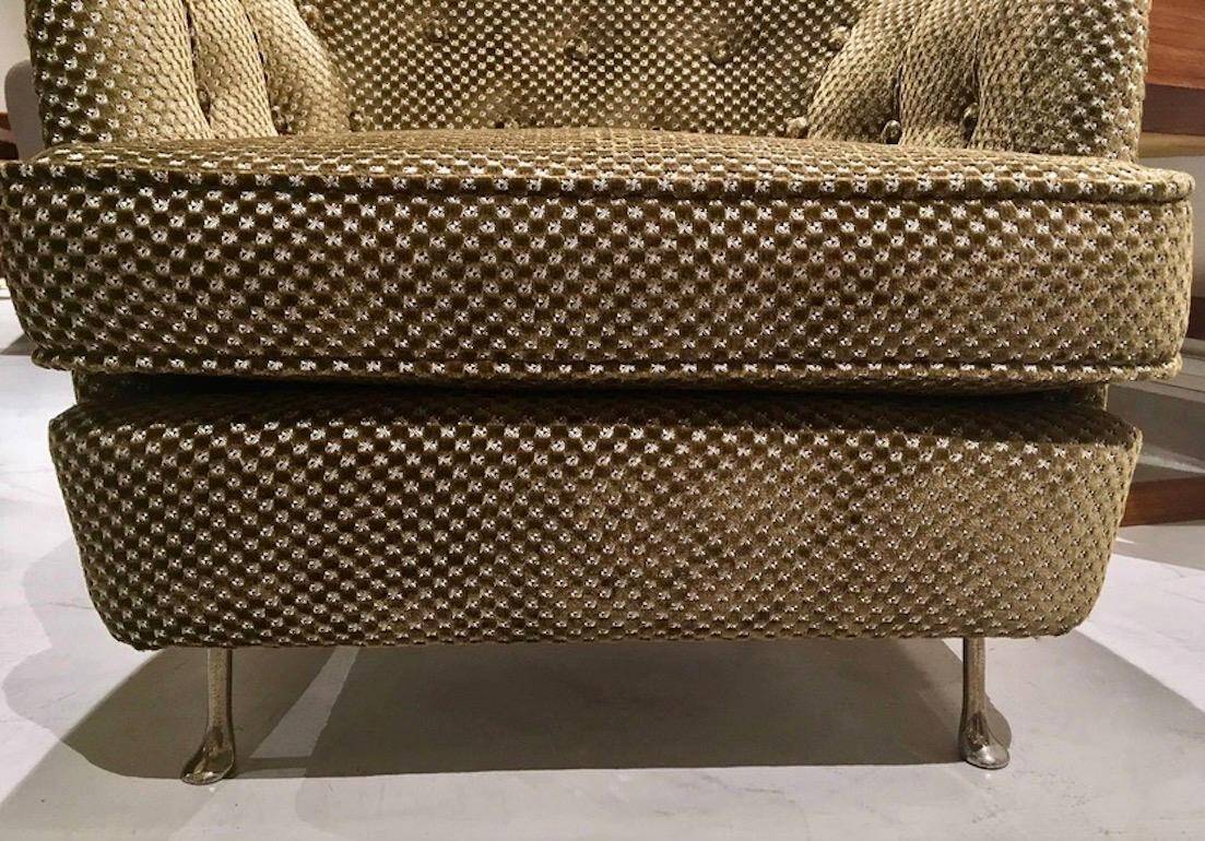 Mid-century buttoned armchair with metal legs