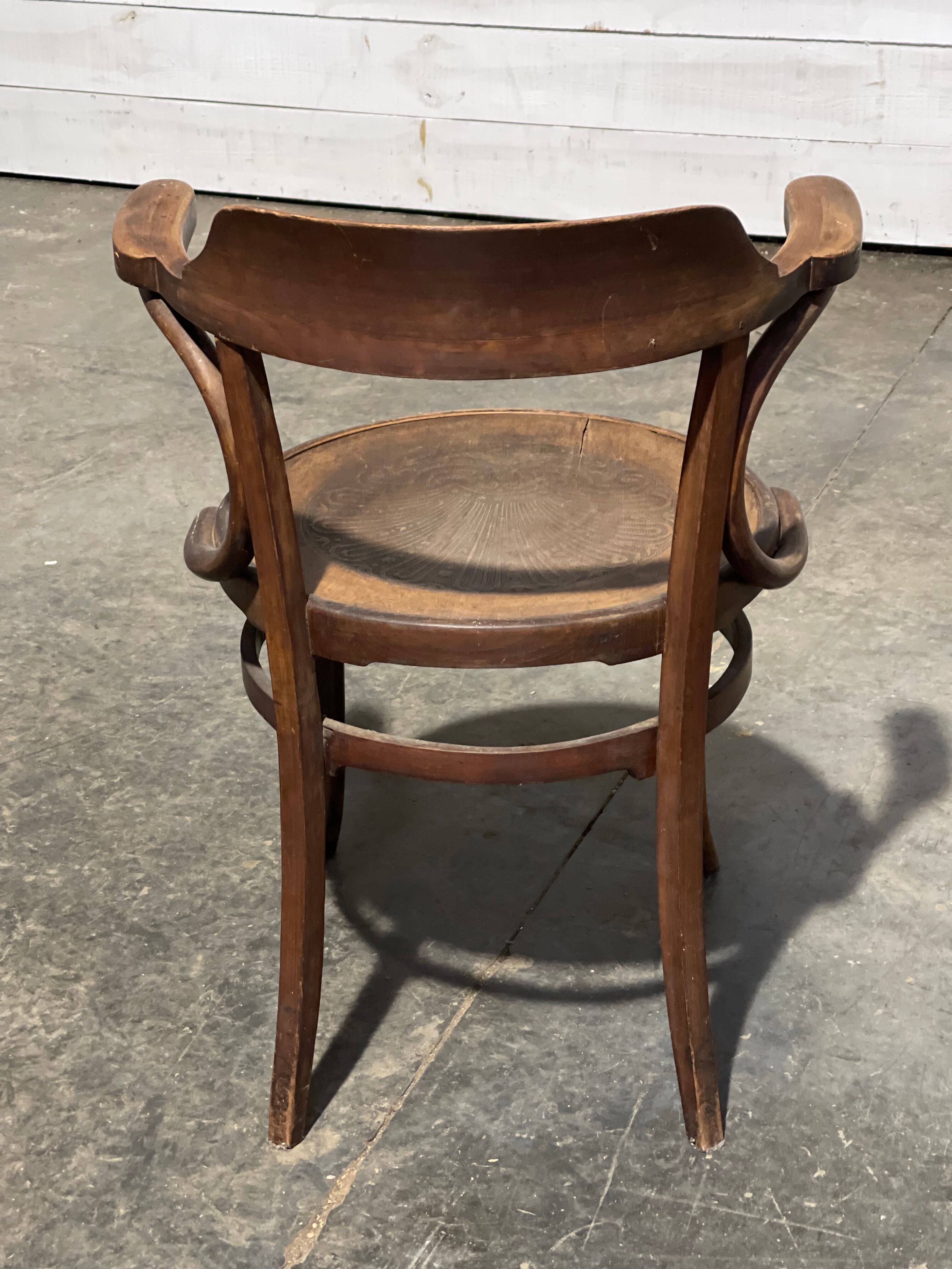 Curved wooden armchair