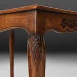Side table with sculpted elements and rattan top