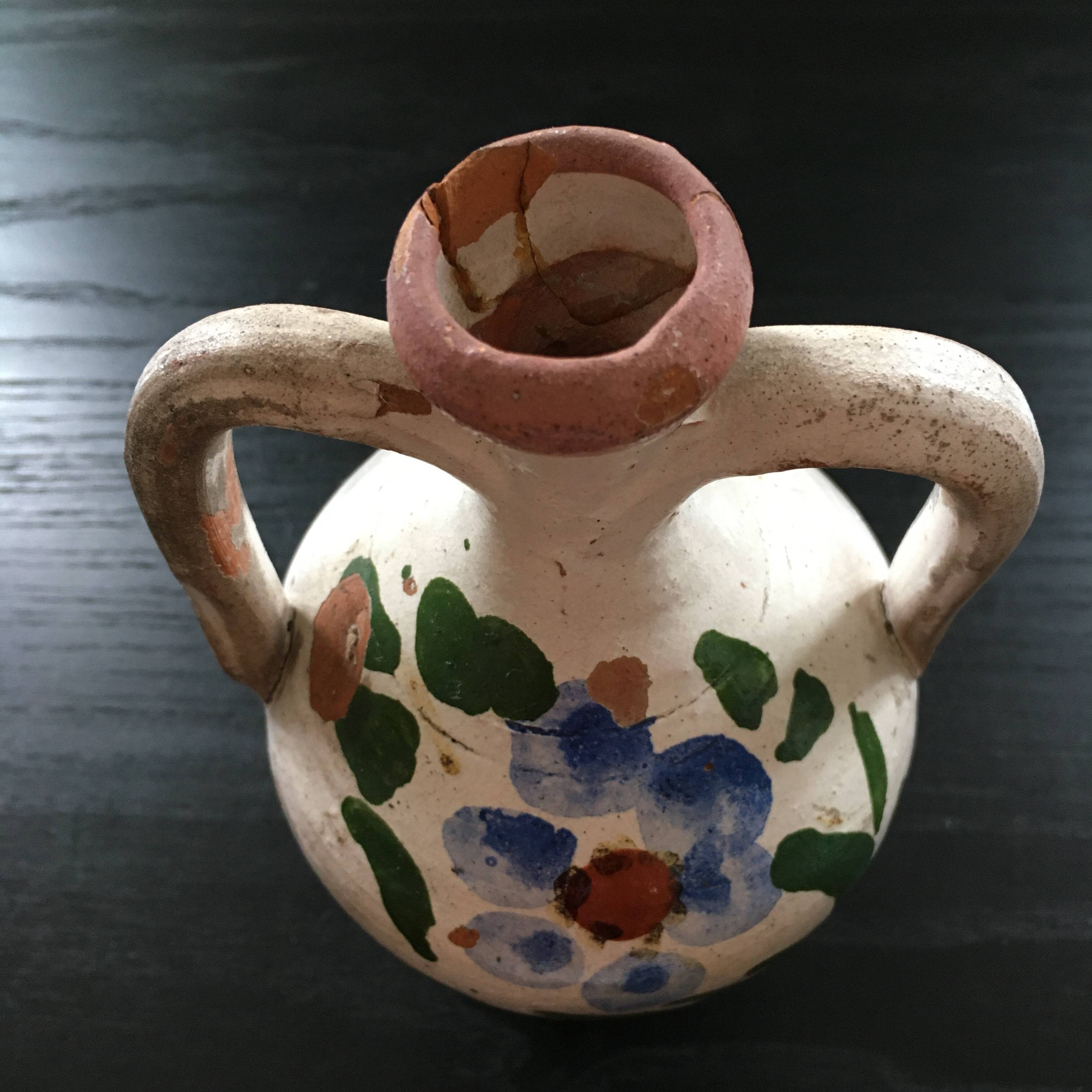 Small old amphora with floral decoration