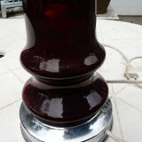 Red glass table lamp on a chrome base.