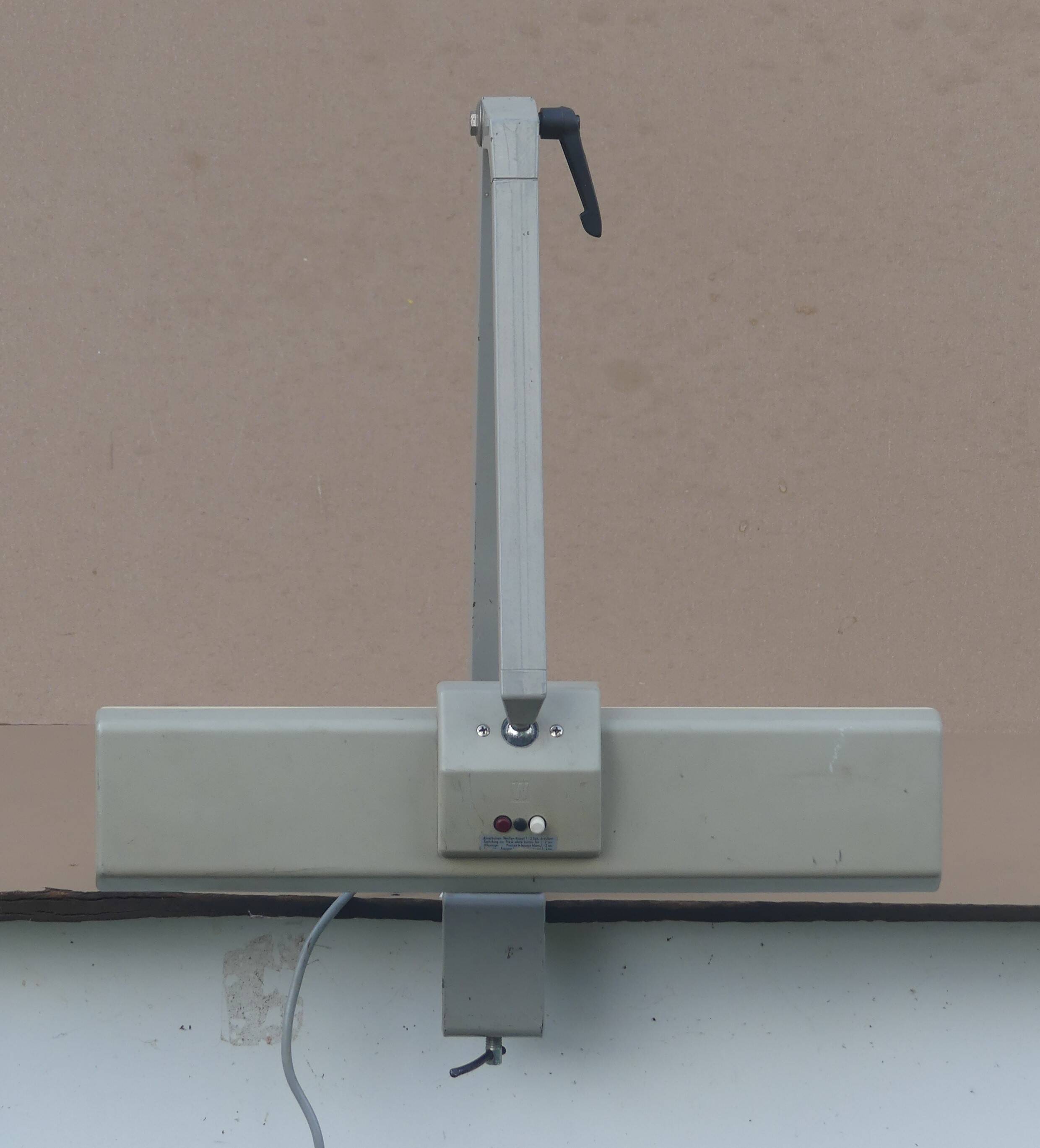 WALDMANN articulated workshop lamp with two industrial clamp arms for architects.
