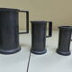 Set of 6 Fleur de Lys pewter measuring pots