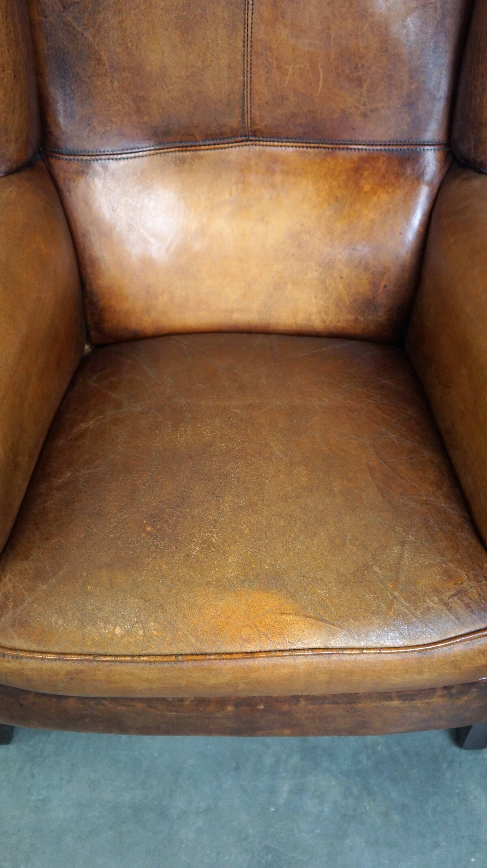 Set of 2 beautiful and correct sheep leather wingback armchairs with fixed seat cushions