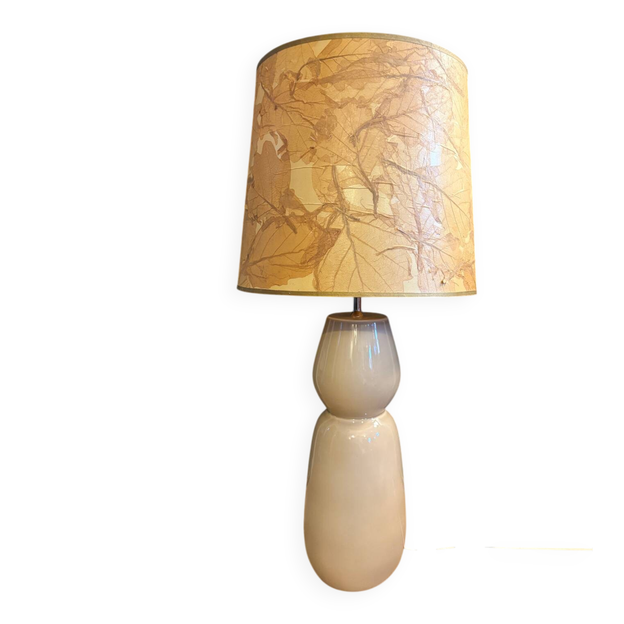 Large beige ceramic table lamp with a vintage shade.