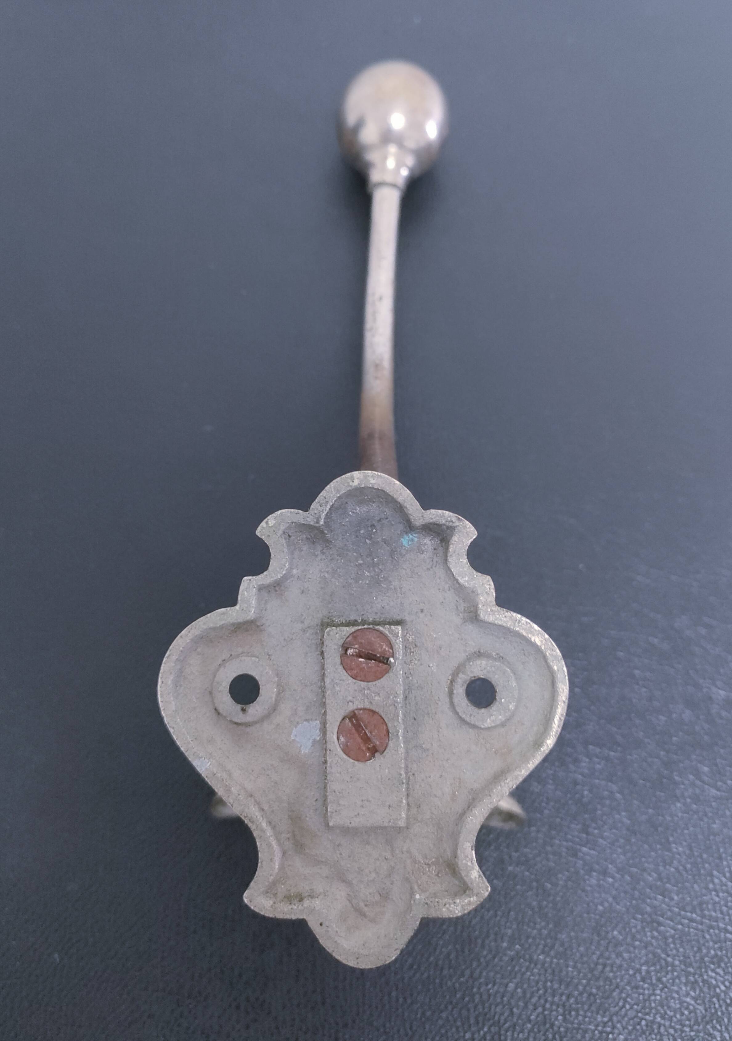 Three enameled cast iron coat hooks and vintage patina metal