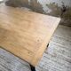 Oak farmhouse table with turned black legs.
