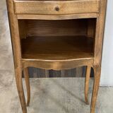 A bedside table with a drawer and a niche in Louis XV style.