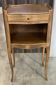 A bedside table with a drawer and a niche in Louis XV style.