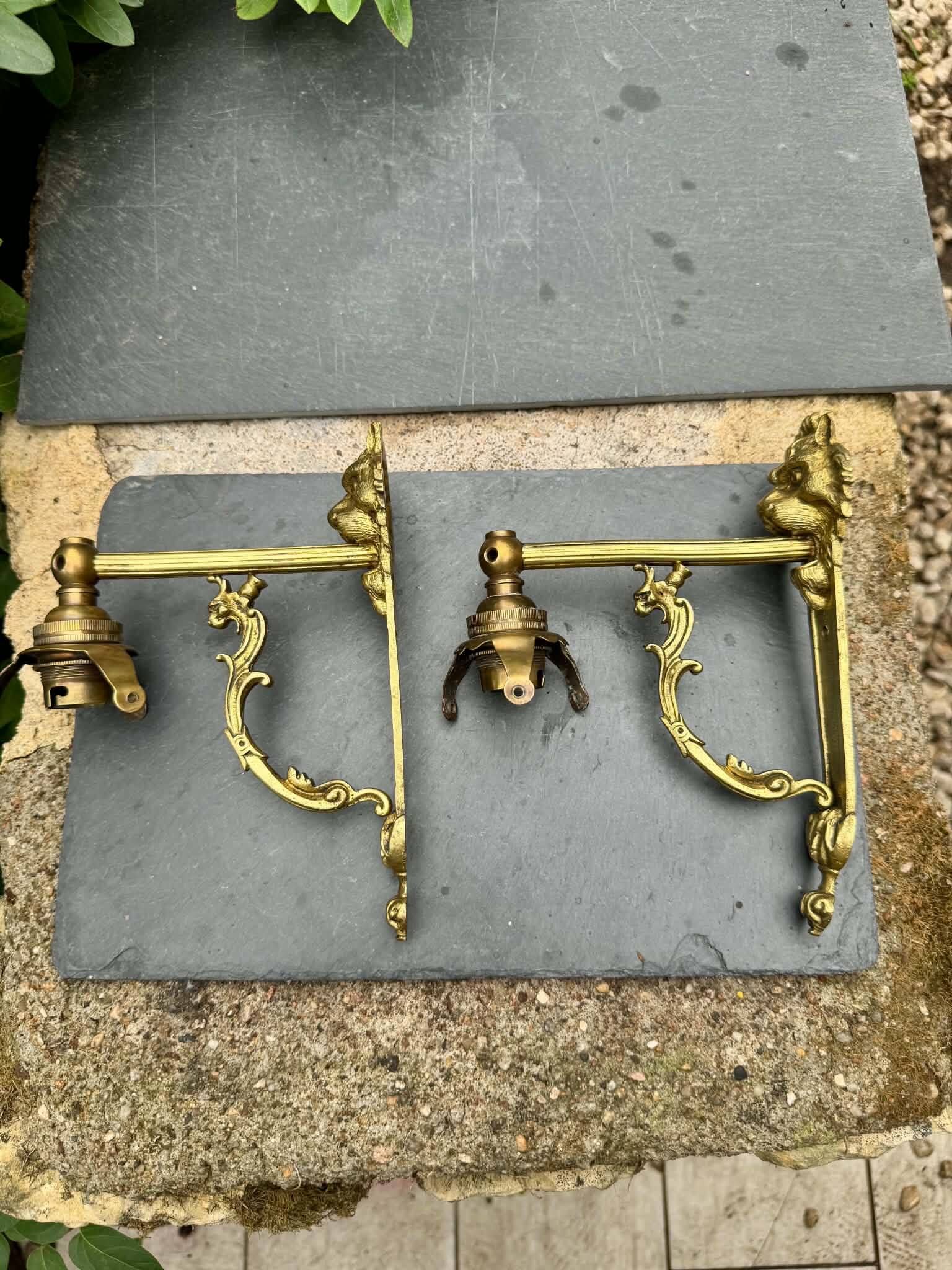 2 brass lion Empire wall sconces