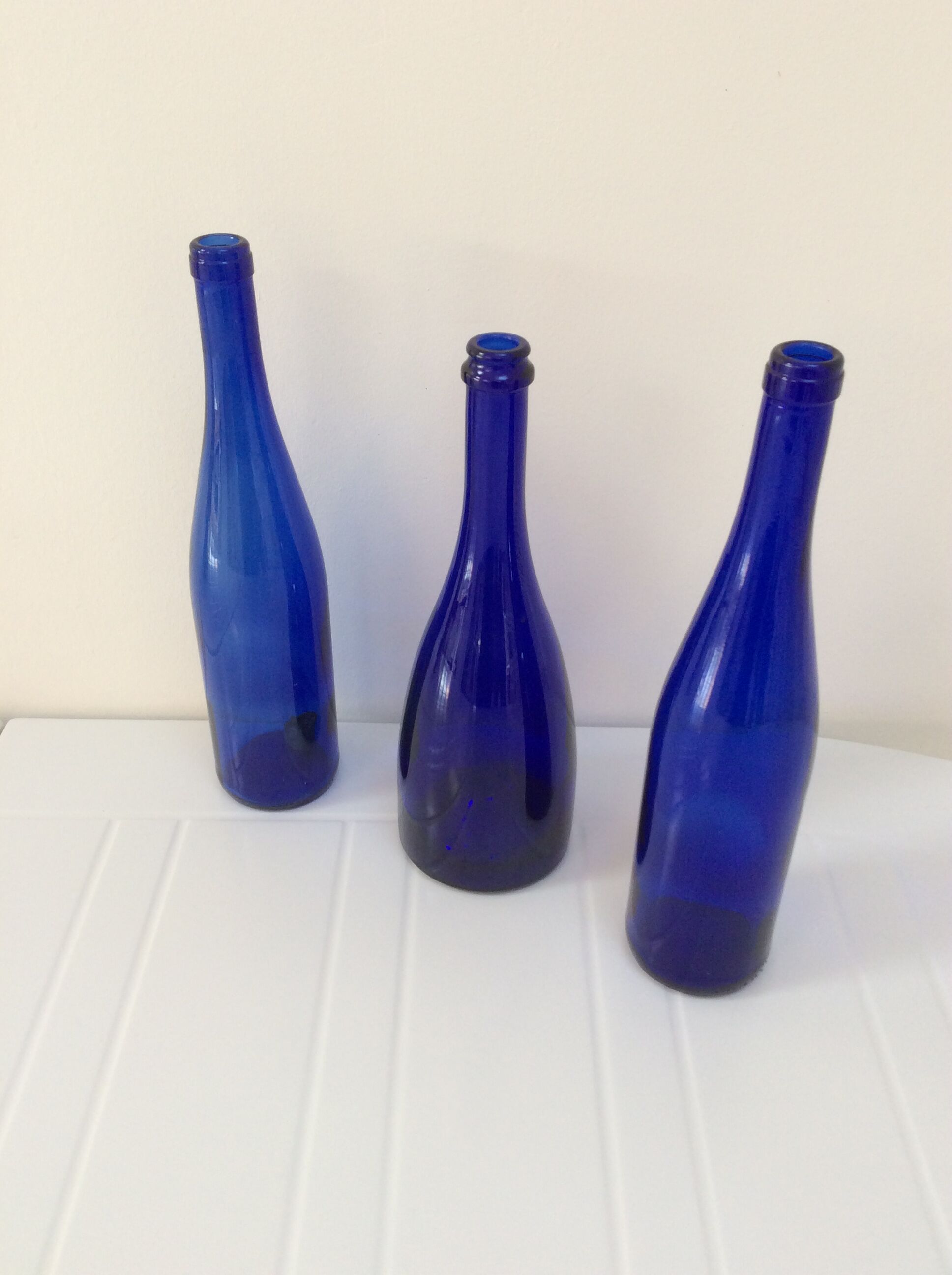Decorative trio of old blue glass bottles