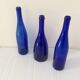 Decorative trio of old blue glass bottles