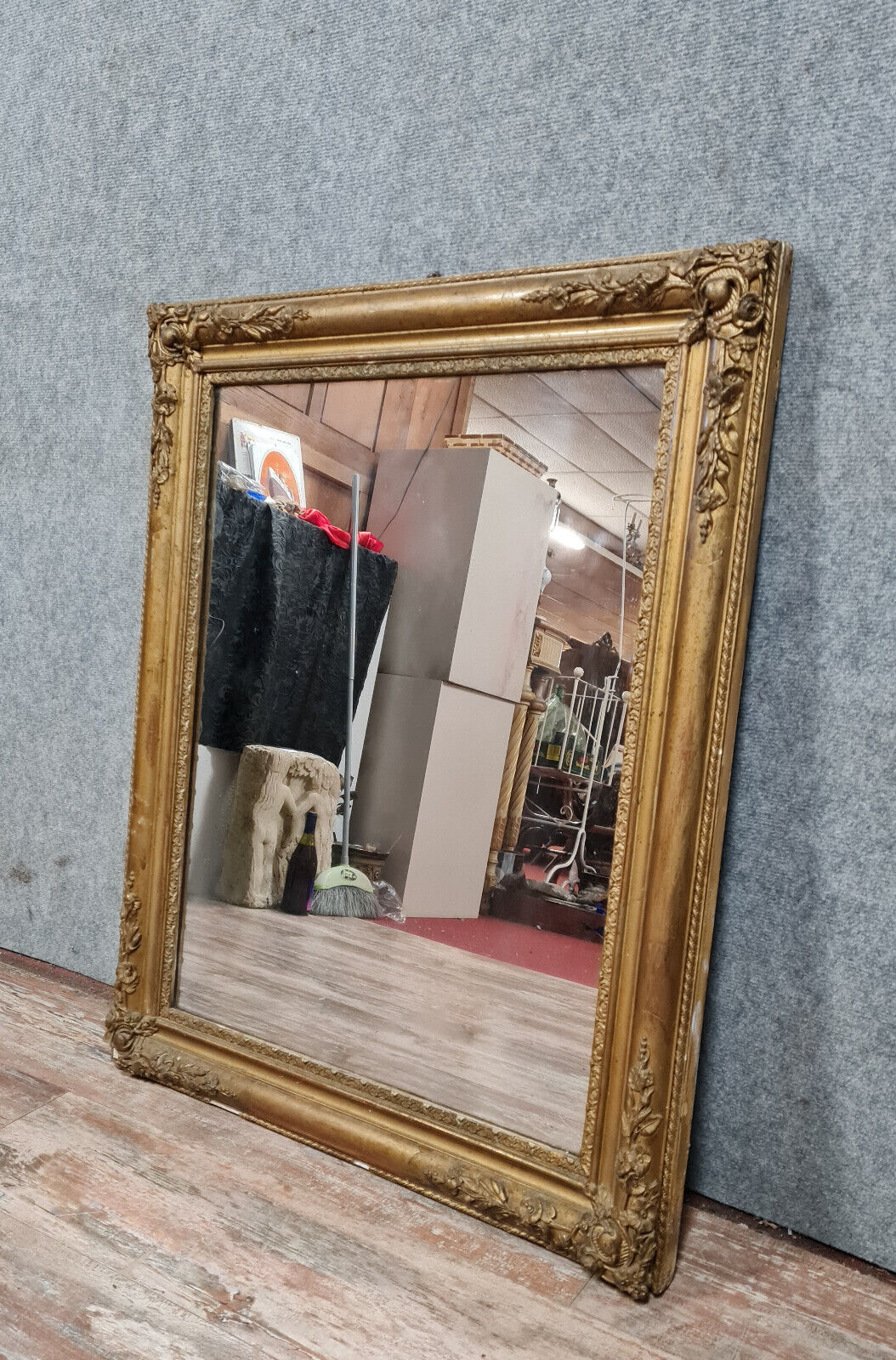 Old nineteenth century mirror in gilded wood and carved around 1850