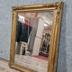 Old nineteenth century mirror in gilded wood and carved around 1850