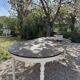 Restored solid wood round table with integrated extensions.