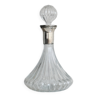 Clear glass carafe with streaked patterns.