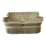 Vintage green two-seater sofa with fringes