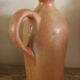 Vintage stoneware liqueur bottle with handle