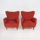 Pair of red armchairs with cone-shaped feet, 1950s