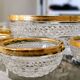 Salad bowl and diamond-shaped bowls in brass.