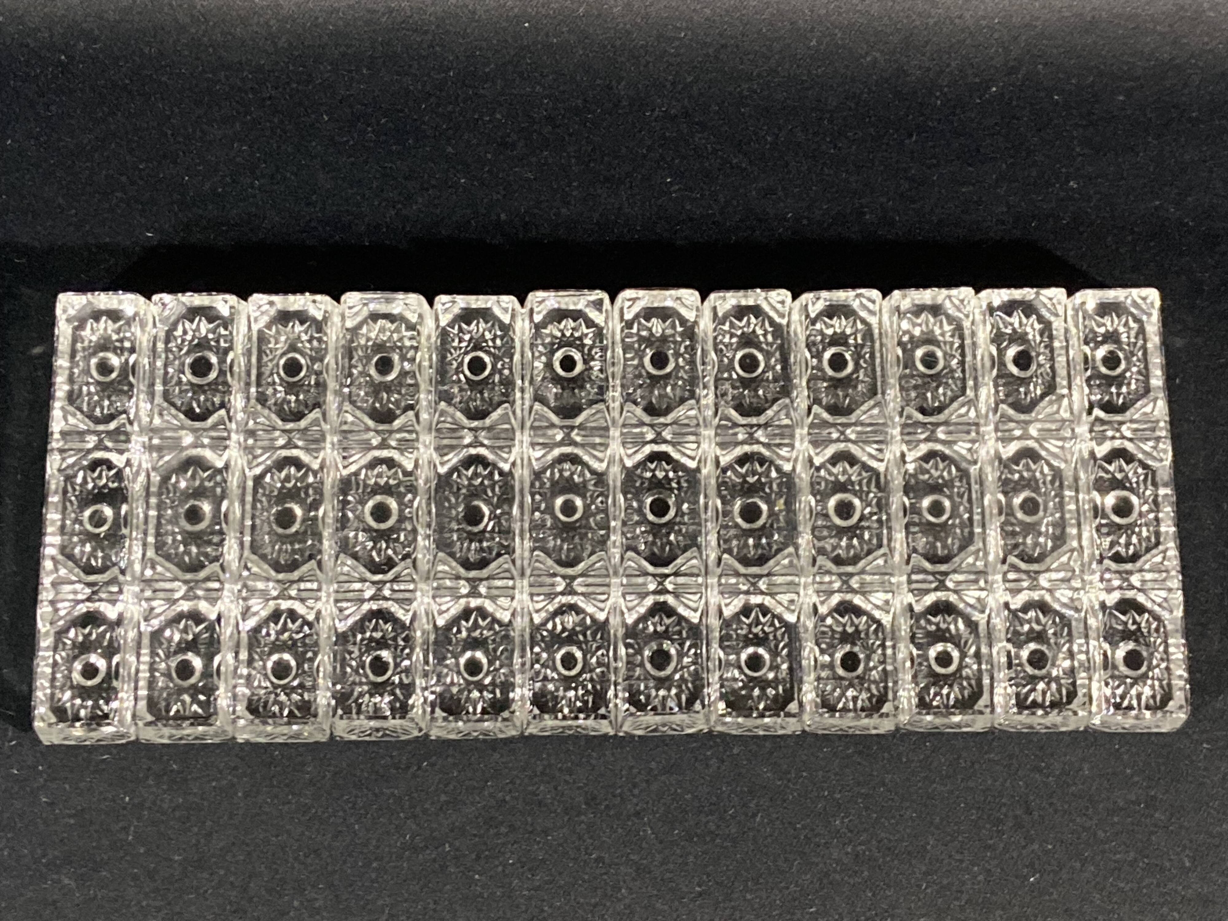 Set of 12 molded glass or crystal knife rests with diamond point decor