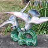 Old barbotine statue seagulls on the wave