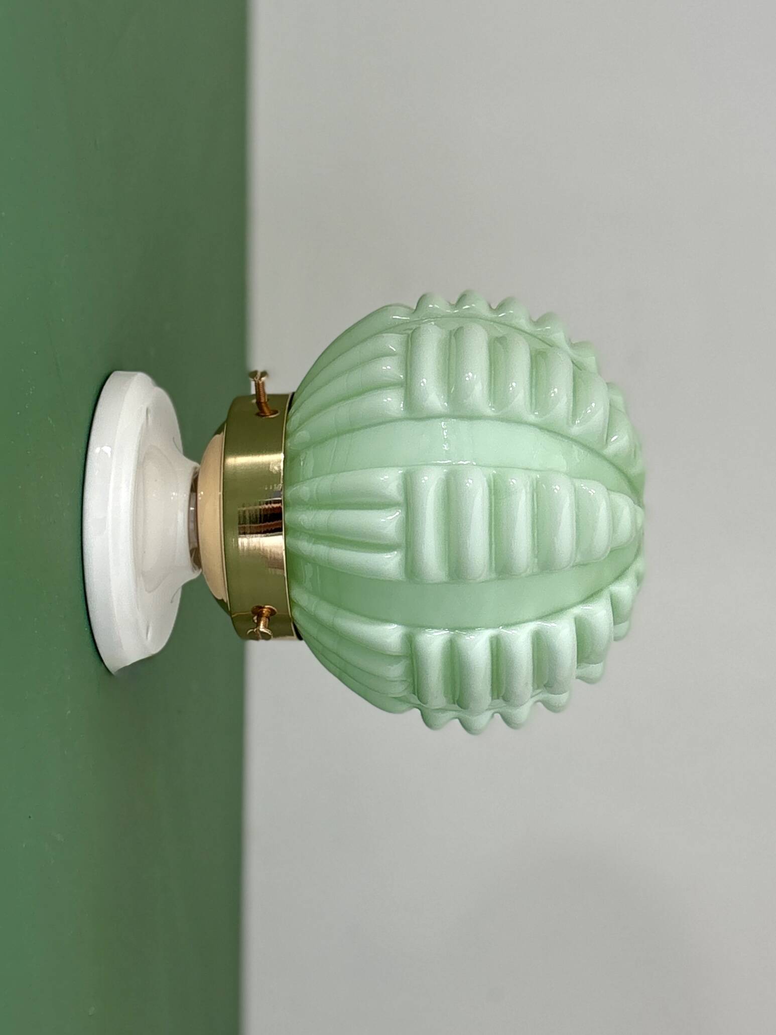 Vintage Art Deco globe wall light in pale green opaline.