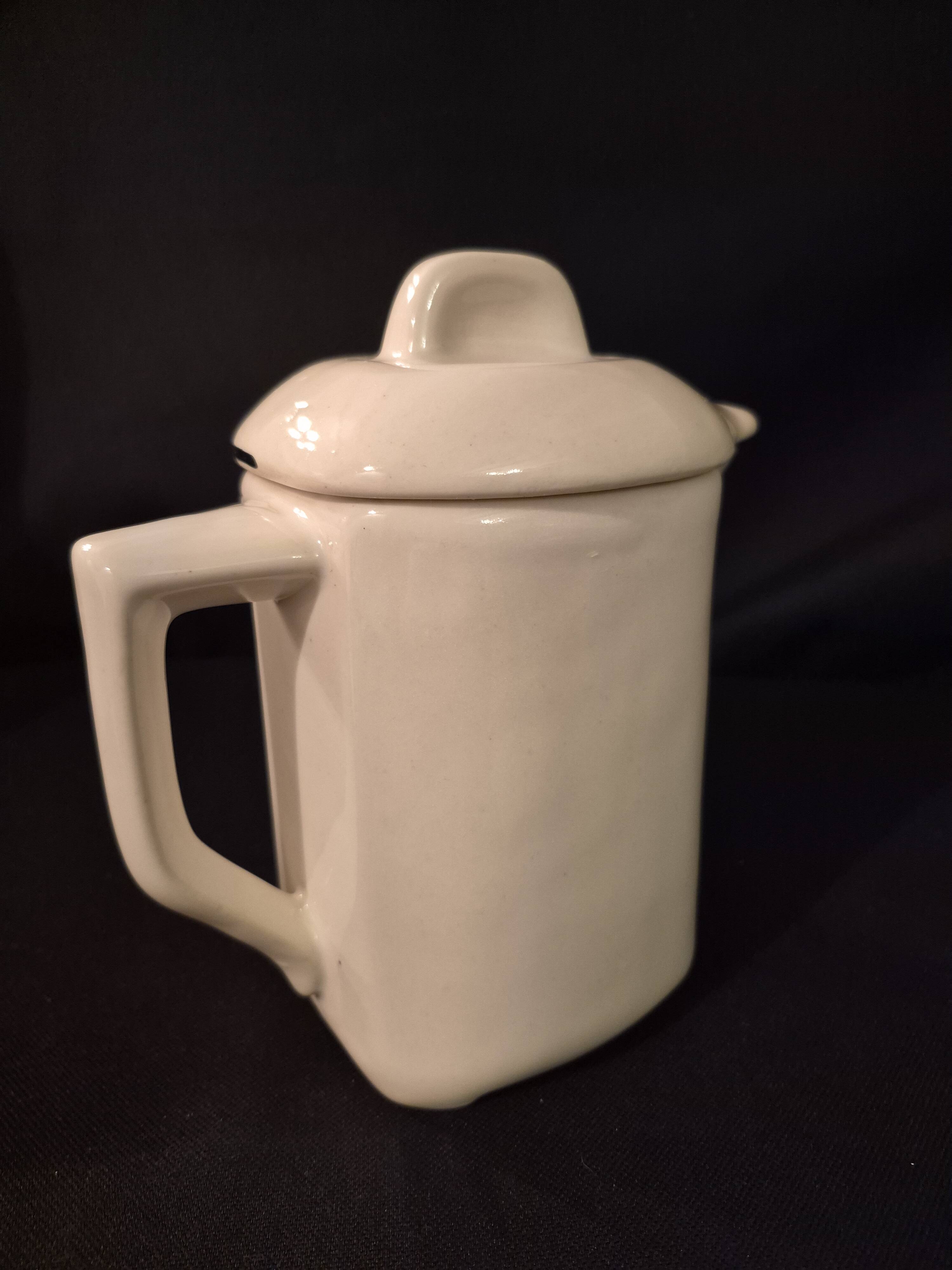 Old covered jug, vintage, geometric frieze with flowers and black trim.