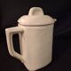 Old covered jug, vintage, geometric frieze with flowers and black trim.