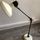 Desk lamp has two articulated metal arms