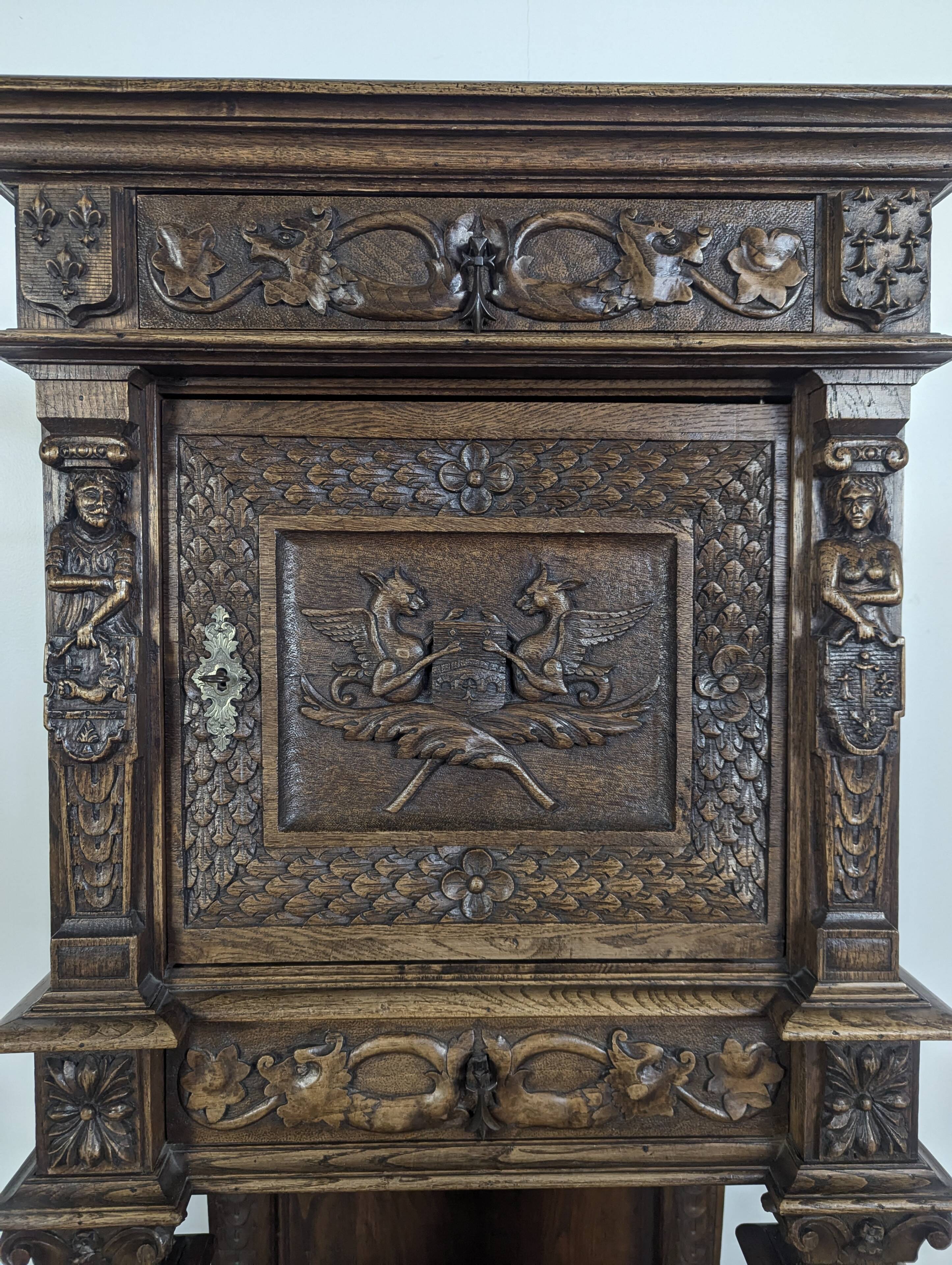 Renaissance-style cabinet in solid oak decorated with chimeras and caryatids