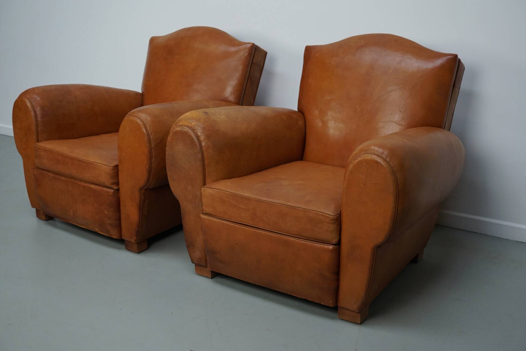 Pair of French club chairs with moustache back in cognac leather, 1950s
