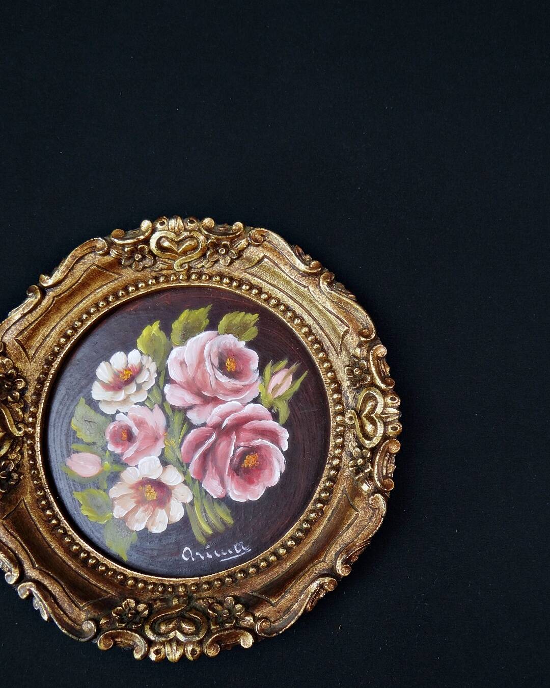 Still life in Tondo oil on panel of a bouquet of pink roses signed