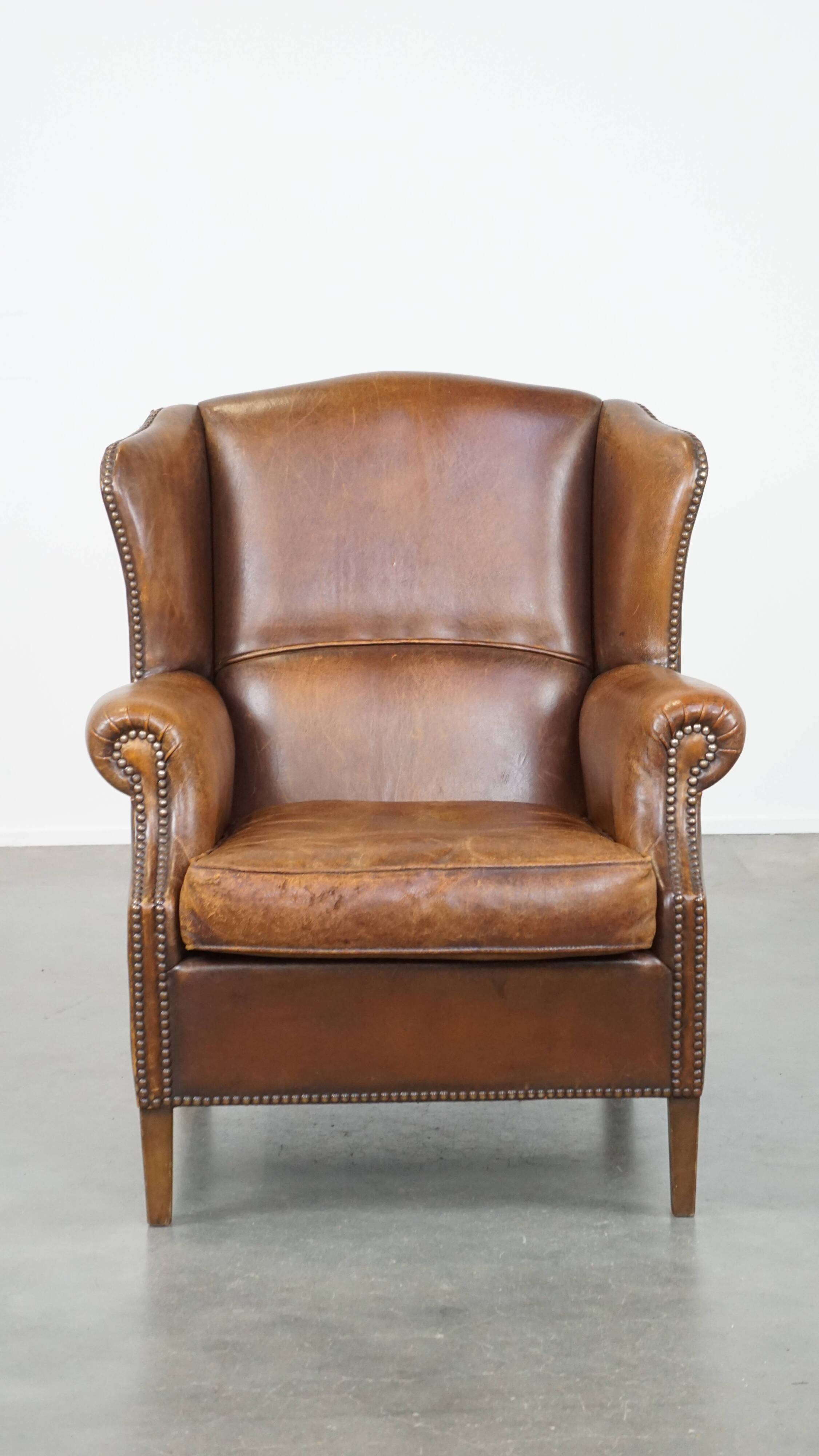 Cognac-colored sheepskin wing chair in English style