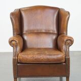 Cognac-colored sheepskin wing chair in English style