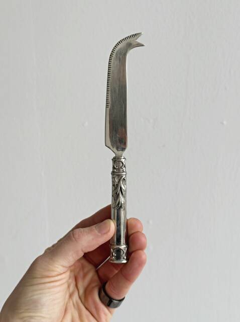 Antique shiny metal cheese cutlery