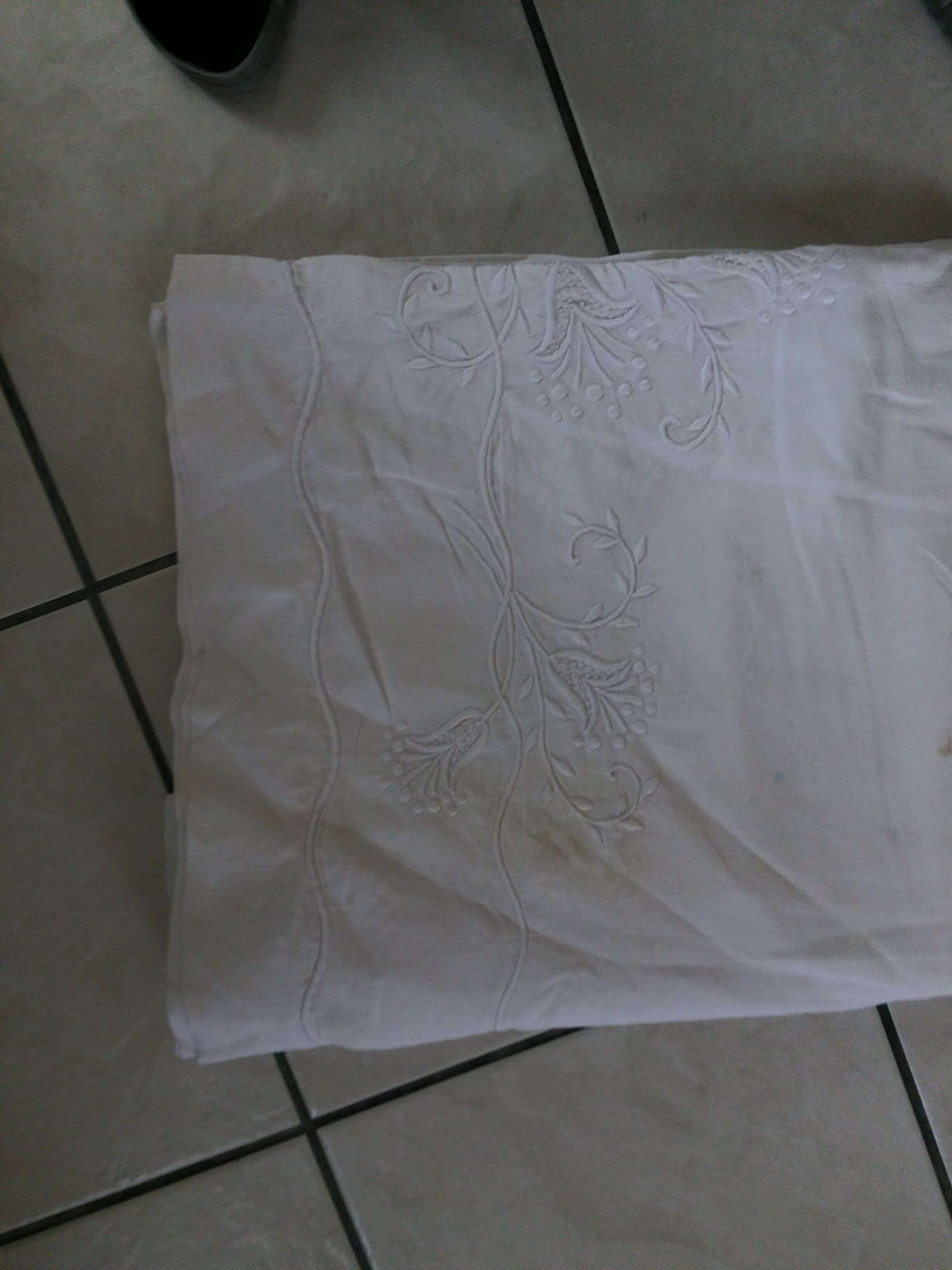 Old sheet with hand made embroidery, shaped flowers.