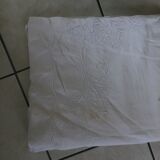 Old sheet with hand made embroidery, shaped flowers.