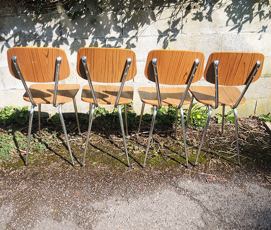 4 old chairs and an extendable table in 'faux wood' formica.
