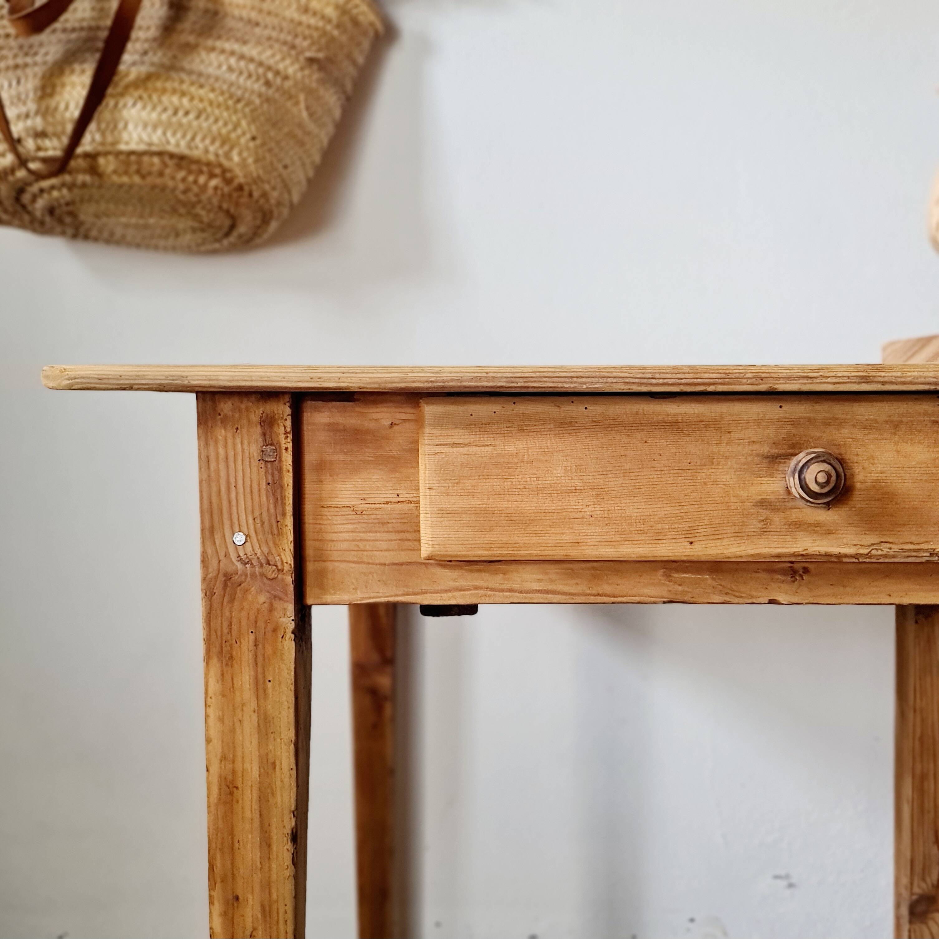 Small old farmhouse table in raw wood.