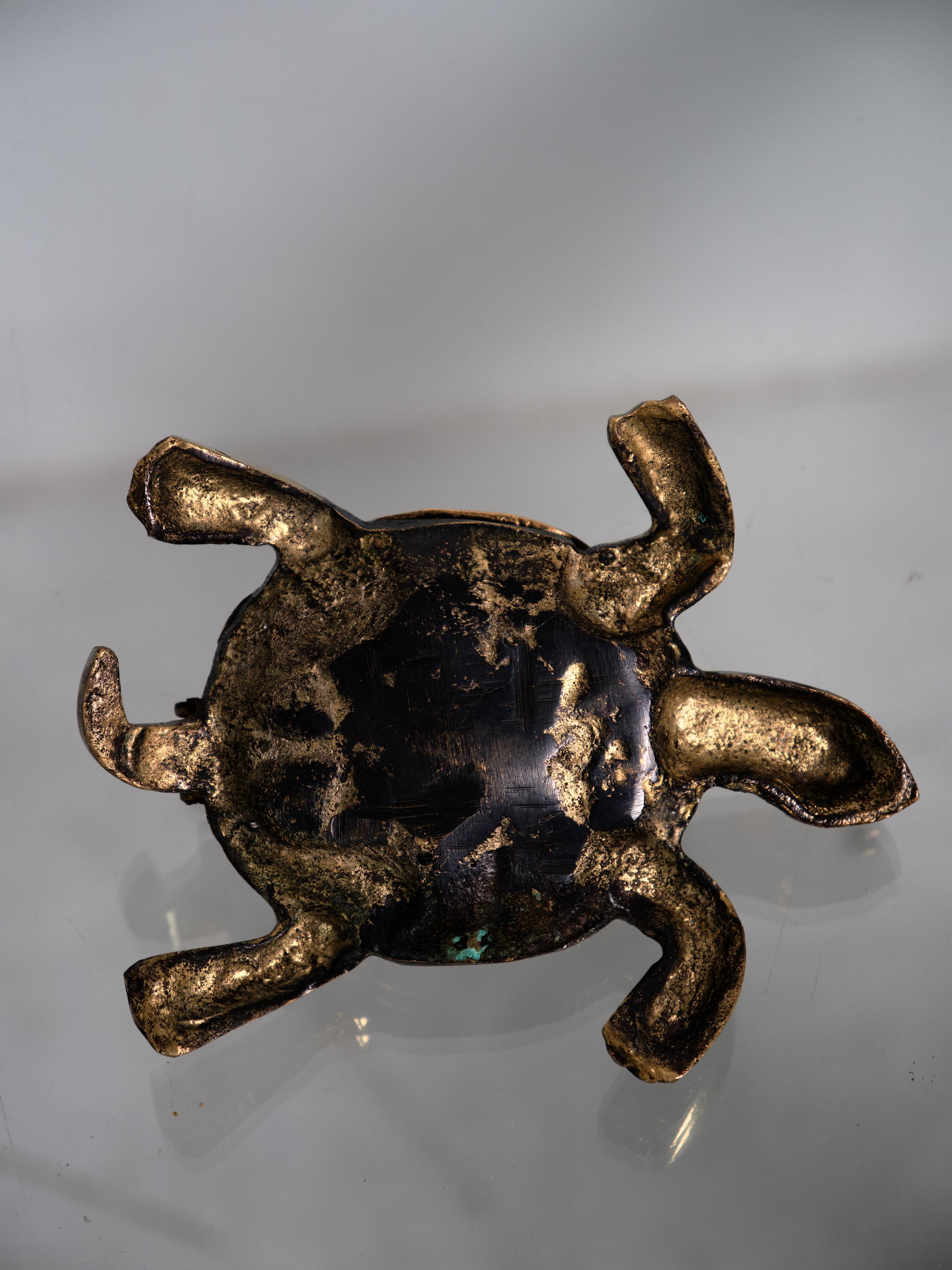 Golden brass turtle in decorative ashtray