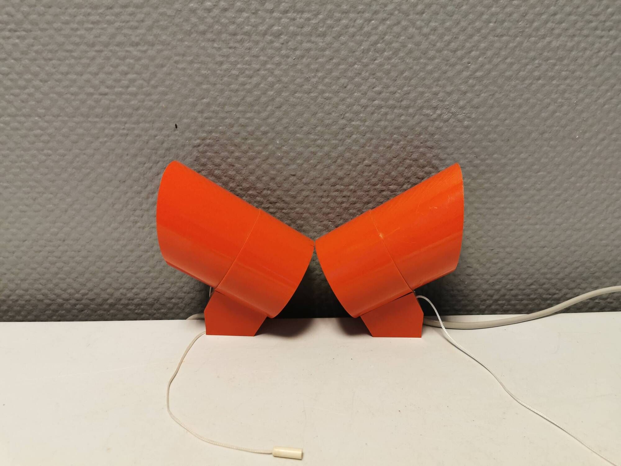 A set of "Nathue" wall lamps (meaning night cap) in a retro red colour, 1970s Denmark.
