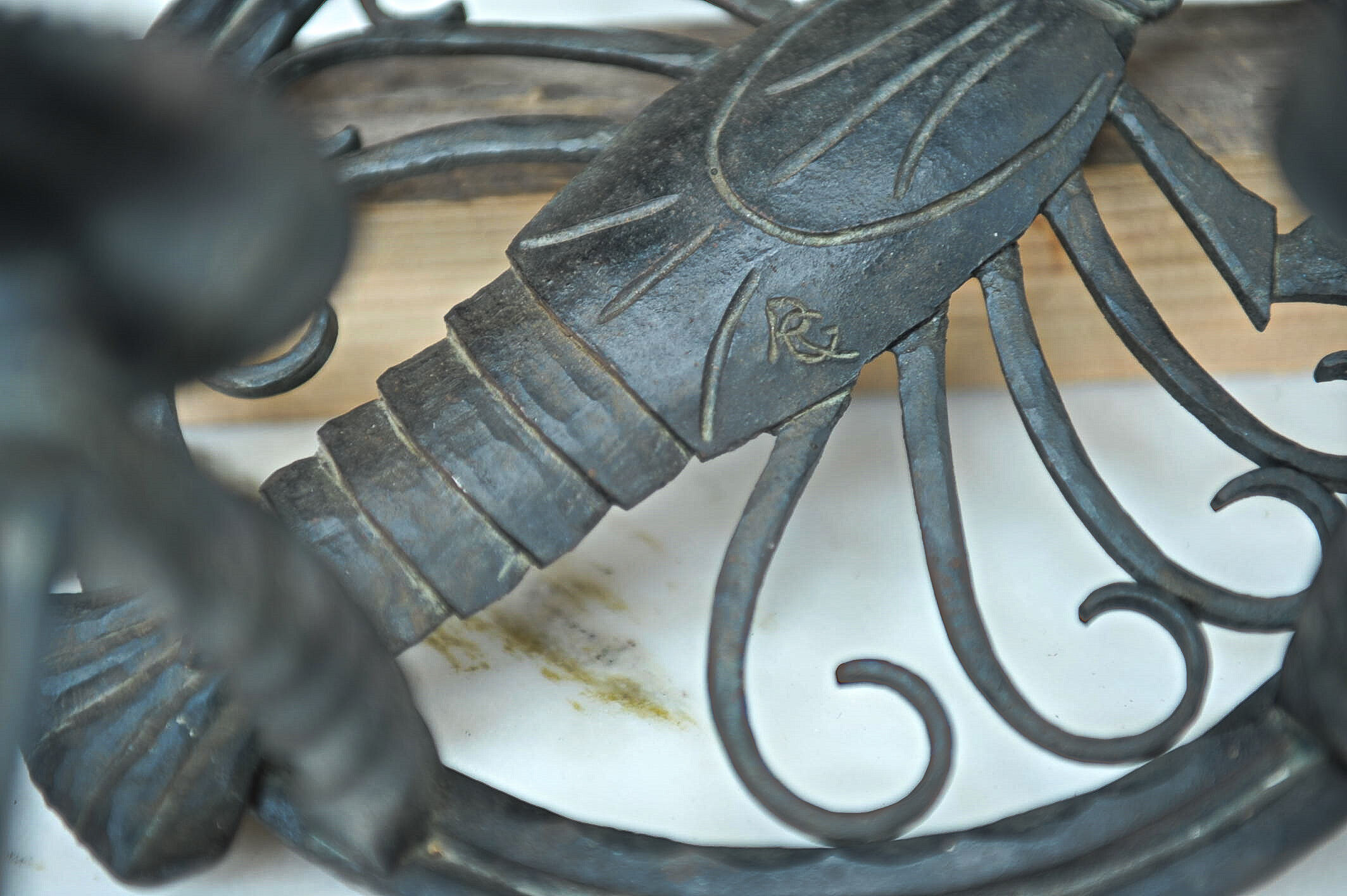 Pair of carved metal wall lamps signed RG