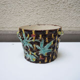 Old earthenware pot with ivy decoration.